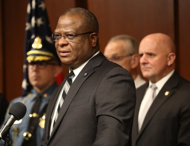 Boston Police Commissioner Michael Cox speaks in March while flanked by other state and local law enforcement leaders including Massachusetts State Police leader Col. Geoffrey Noble, at far right. (Nancy Lane/Boston Herald)