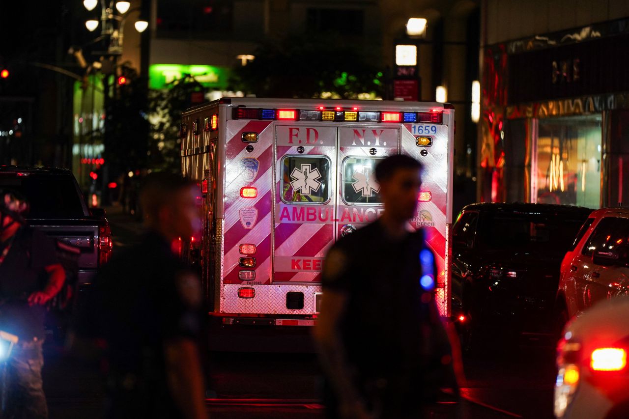 An ambulance departs the scene of of the shooting in Manhattan on Monday.