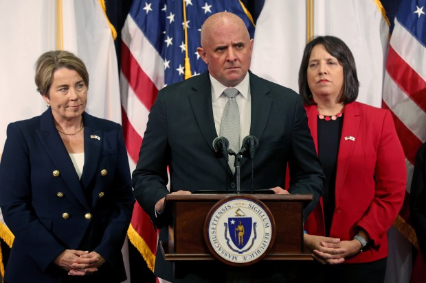 Colonel Geoffrey Noble speaks after being sworn into the Massachusetts State Police last October as Gov. Maura Healey, left, and Lt. Gov. Kim Driscoll look on. (Photo By Matt Stone/Boston Herald)